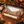 Craft beer advent calendar box on a wooden counter beside three decorated cans, with holiday greenery and warm lights.